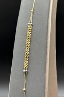 اسوارة شوطين مجدول لونين ذهب صافي عيار 18 وزن من 1...