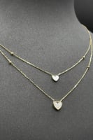 عقد قلب دورين ذهب مع صدف ابيض عيار 18 وزن من 2.2 ا...