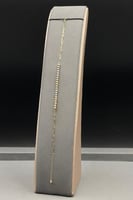 اسوارة ذهب عيار 18 صافي بتصميم كور ملونة بوزن 0.8...