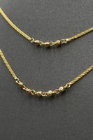 طقم شكل X ذهب صافي عيار 21