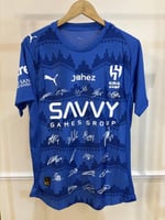 تيشيرت الهلال الأساسي 2025/26 مُوقع من نجوم الفريق