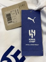 تيشيرت الهلال الاحتياطي 2025/26 مُوقع من نجوم الفر...