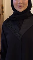 عباية سوداء سادة مزينه بتفته من الرقبة ومن الاكمام...