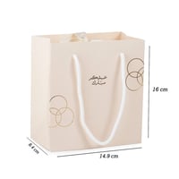 أكياس فاخرة للعيد لون بيج بدوائر ذهبية وختم "عيدكم...