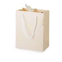 أكياس فاخرة للعيد لون بيج بدوائر ذهبية وختم "عيدكم...