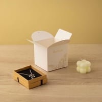 علبة توزيعات لون أبيض بزخرفة ذهبية بتصميم فاخر بشر...