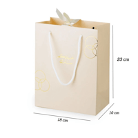 أكياس فاخرة للعيد لون بيج بدوائر ذهبية وختم "عيدكم...