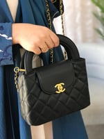 شنطة نسائية بشعار ذهبي