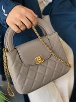 شنطة نسائية بشعار ذهبي