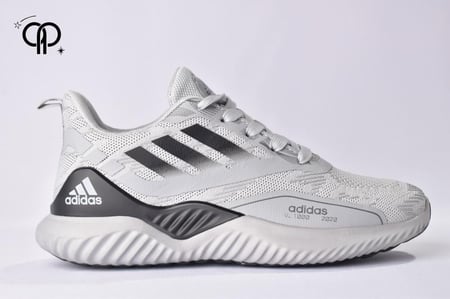حذاء رجالي اديداس رمادي مع أسود an Adidas AlphaBOUNCE+ running shoe in light gray with black accents.