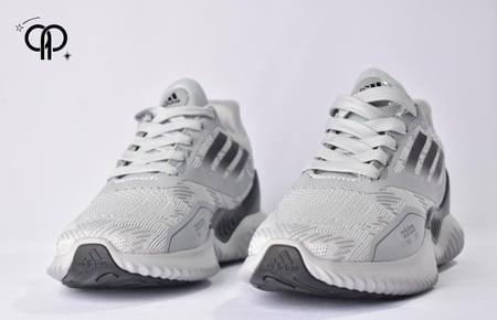 حذاء رجالي اديداس رمادي مع أسود an Adidas AlphaBOUNCE+ running shoe in light gray with black accents.