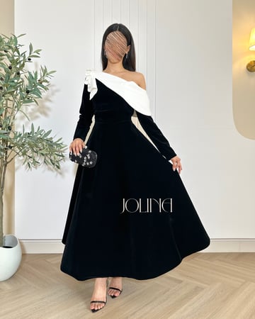 فستان مخملي أسود مع فيونكة بيضاء