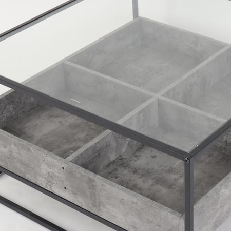 طاولة قهوة وسط رمادي – زجاج وخانات تنظيم خرسانية