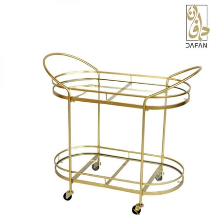 عربة شاي ذهبية بيضاوية توضح تناسق الشكل البيضاوي مع الطلاء الذهبي الفا