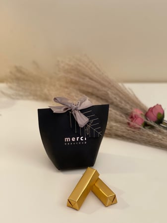 حقيبة توزيعات بشعار Merci مع حلوى منوعة