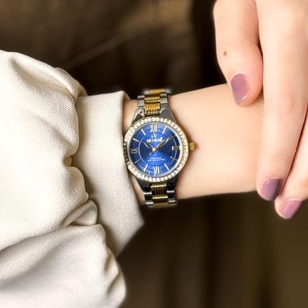 ساعة نسائية استيل بلون فضي و ذهبي اطار ذهبي ميناء ازرق