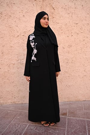 عباية بليزر كريب سوداء بتطريز امامي باللون الوردي