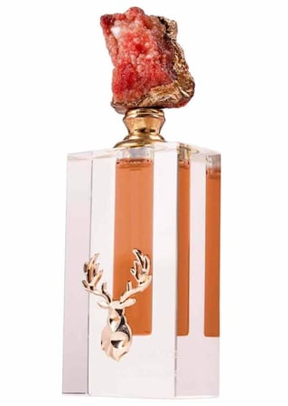 كرستالة مسك شدون احمر مع حجر كريم عليها شعار الغزال من متجر مسك غزال