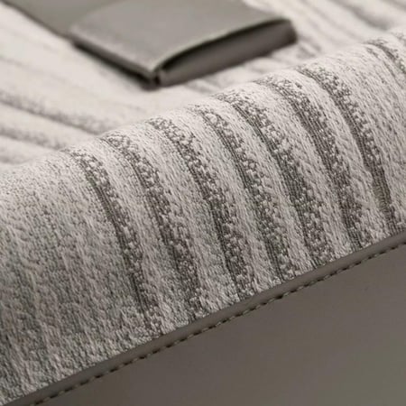 غطاء وسادة رمادي بتفاصيل جلد وحزام فضي