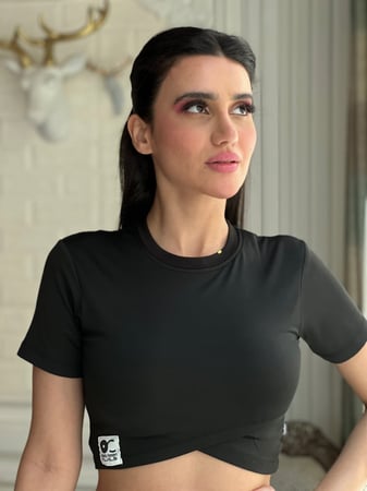 ترينق اسود رياضي بنطلون سكيني مفتوح من أسفل وبلوزة نص كم بقصة مائلة من البطن