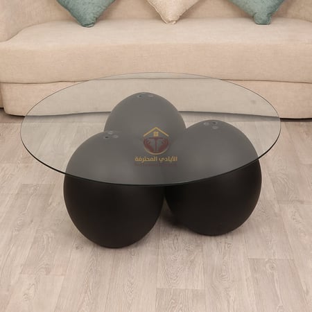 طاولة شكل كره رخام صناعي لون اسود سطح زجاج شفاف-متجر الايادي المحترفه