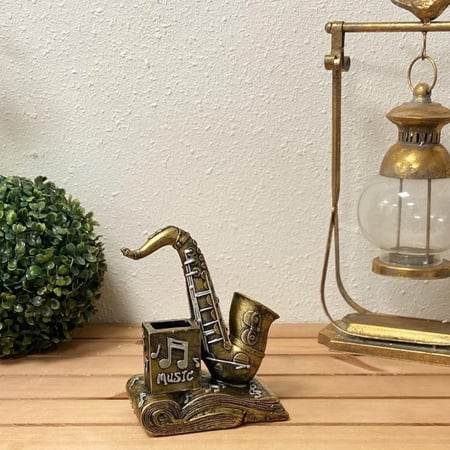 ساكسفون بكتاب مقلمية تحف وهدايا ديكورات سيراميك ساكسفون نوتة موسيقيه