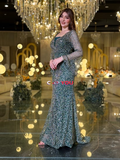 فستان سهرة اخضر مطرّز بقصّة حورية ورقبة V وأكمام شفافة مع شال جانبي.