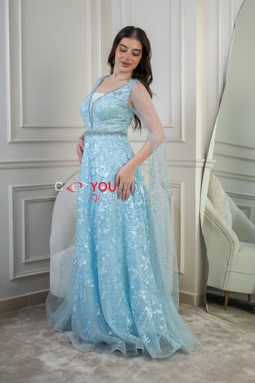 فستان سهرة أزرق فاتح بتطريز أنيق وأكمام شفافة، تصميم فاخر يبرز الأنوثة.