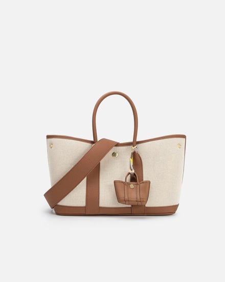 ‎ شنطة نسائية من القماش والجلد بلون بني وبيج