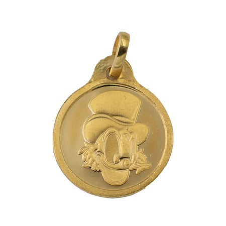 جنيه ذهب أنكل سكروج عيار 24 بي تي سي بوزن 8,2 غرام مع تعليقة