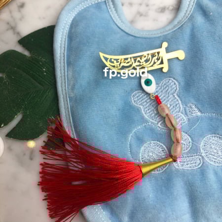 بروش السبحه السيف مطلي ذهب مع خرزه زرقاء بيضاوي ودندوش