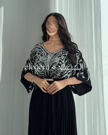 فستان أسود أنيق بتطريز شك كامل من الخلف وكسرات ناعمة