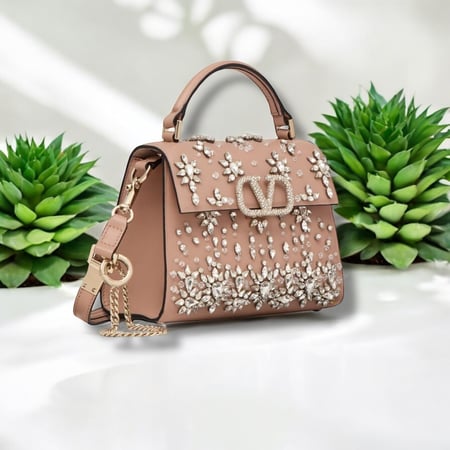 Triangular side profile of Valentino embellished pink handbag