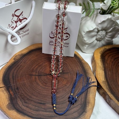 مسباح بكلايت شفاف خيط أحمر مذهّب كركوشة