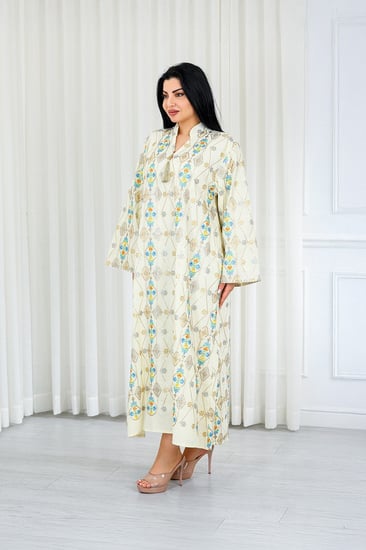 جلابية قماش بطول يصل للكاحل ونهايات أكمام واسعة وياقة صغيرة مفتوحة على الصدر مزينة بتطريزات هندسية بارزة على كامل القماش