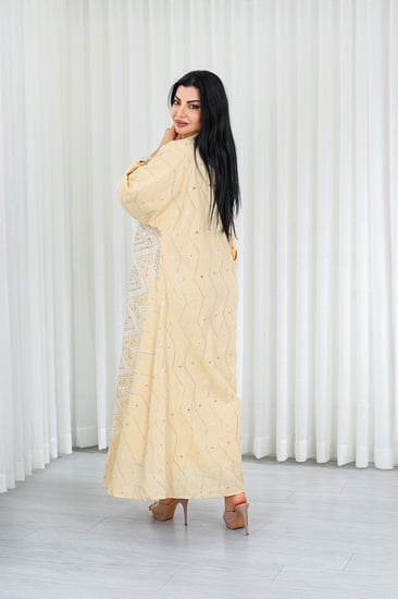 جلابية قماش بطول يصل للكاحل بأكمام واسعة متوسطة الطول وياقة صغيرة مزينة بالترتر اللامع وبالتطريزات على كامل القماش