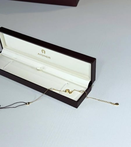 اجنر اسوار فاشن ذهبي بالعلامه و اللولو Aigner fashion bracelet pearl