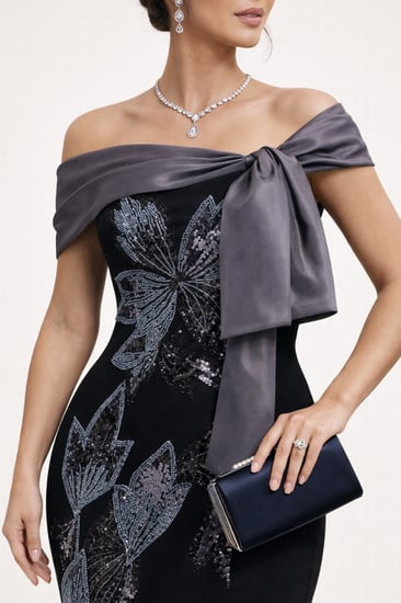 فستان سهرة فاخر بتصميم أوف شولدر وتفاصيل فيونكة أنيقة