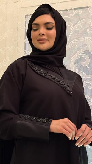 عباية سوداء سادة مزينه بتفته من الرقبة ومن الاكمام مع تطريز بالفصوص بشكل انيق