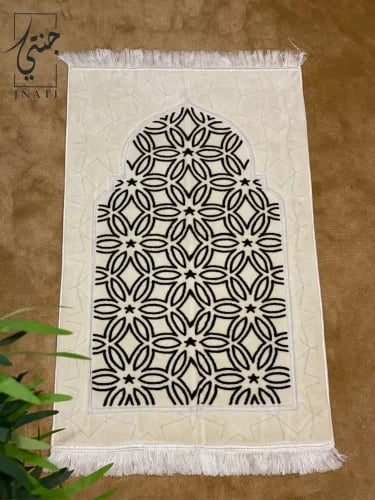Beige prayer rug with Islamic patterns in black
