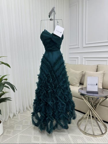 فستان سهره ناعم بكسرات أنثوية ولمسة فخامة زمردية