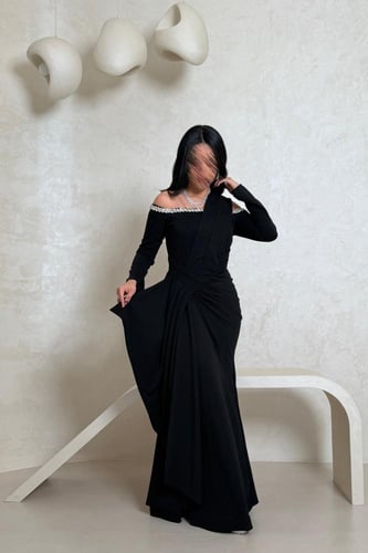 فستان أسود أنيق بتفاصيل لامعة على الأكتاف