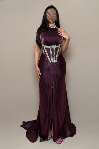 Luxurious purple dress with an embellished corset design and shimmering details.
