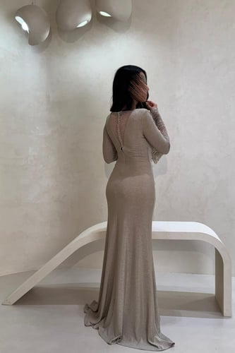 فستان سهرة ذهبي بقصة ضيقة وأكمام لامعة