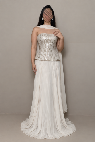 Off-white evening dress with a sequin corset and a long flowing shawl.