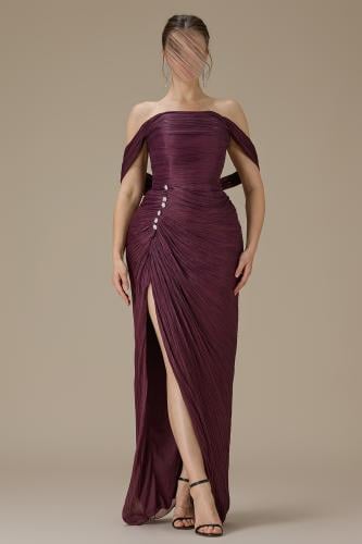 Long burgundy dress with draped sleeves and pleated details.