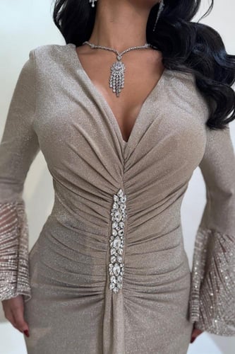 فستان سهرة ذهبي بقصة ضيقة وأكمام لامعة