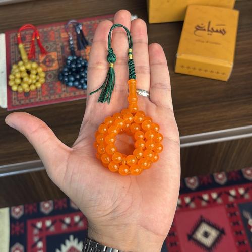 A prayer bead with soft beads - in a semi-transpar...
