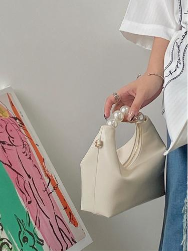 Small satchel bag decorated with artificial beads