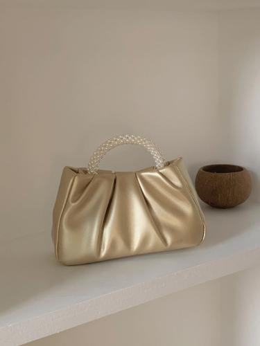 Folded shoulder bag decorated with artificial beads